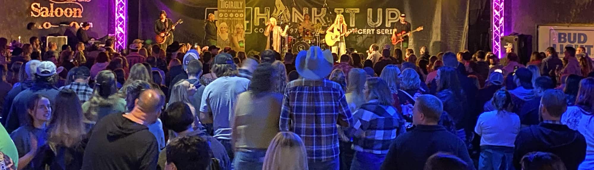 country concert with fans wearing cowboy hats Dallas