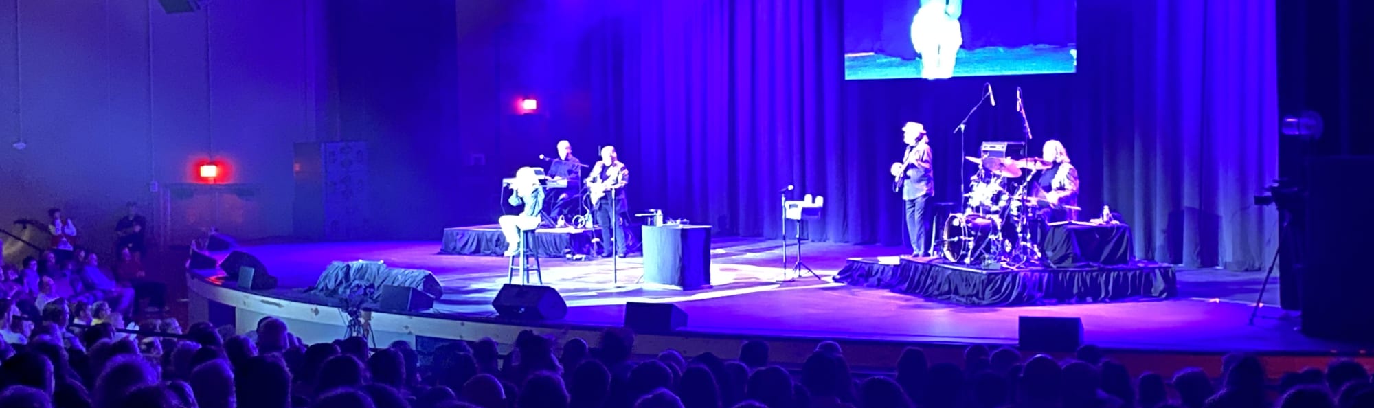 signer on stage in chair washed out by the lights Dallas